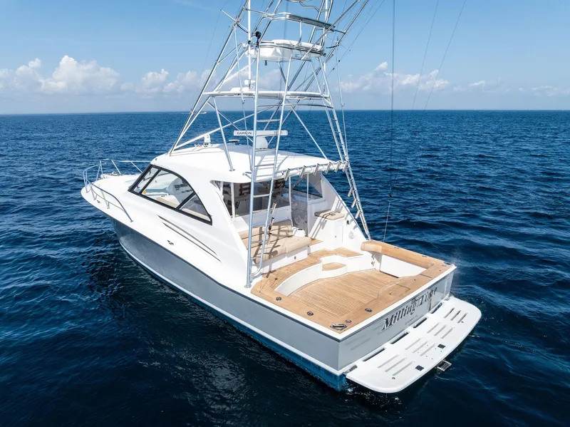 Slide: The Image of 2016 Hatteras Express Sportfish yacht cruising on open ocean waters. - 21
