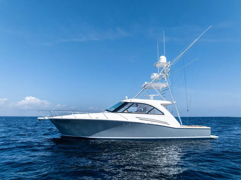 Slide: The Image of 2016 Hatteras Express Sportfish yacht on open sea under clear blue sky. - 24