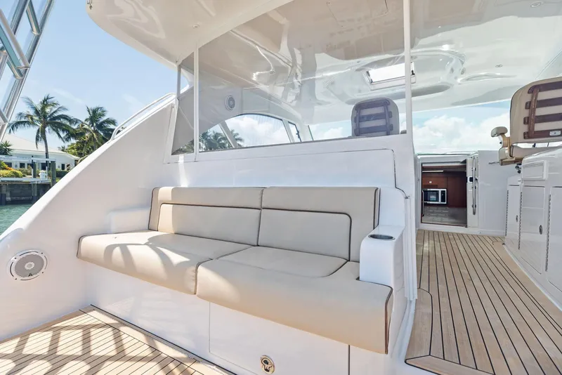 Slide: The Image of 2016 Hatteras Express Sportfish yacht with spacious deck seating and modern interior. - 28