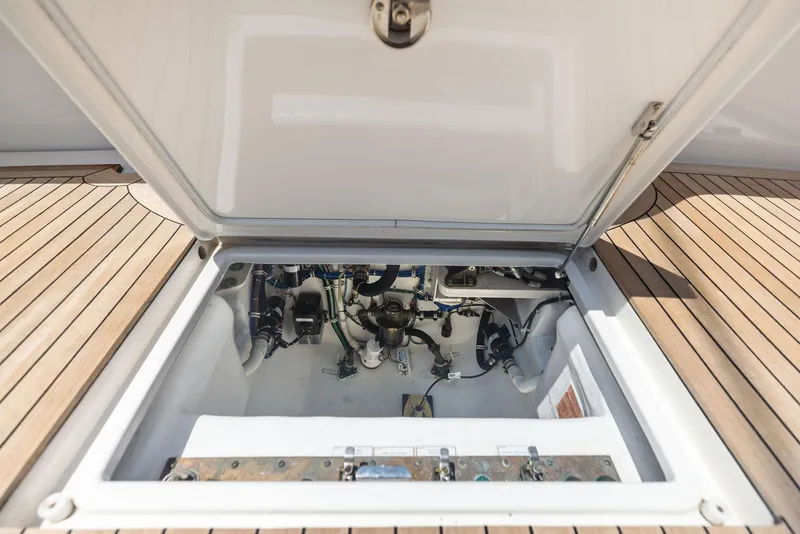 Slide: The Image of Engine compartment of 2016 Hatteras Express Sportfish with open hatch on teak deck. - 34