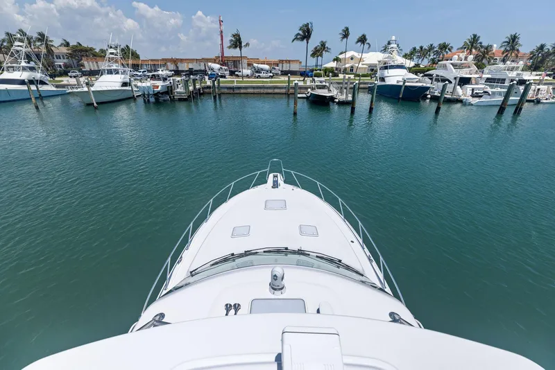 Slide: The Image of Bow view of 2016 Hatteras Express Sportfish in a marina with palm trees. - 37