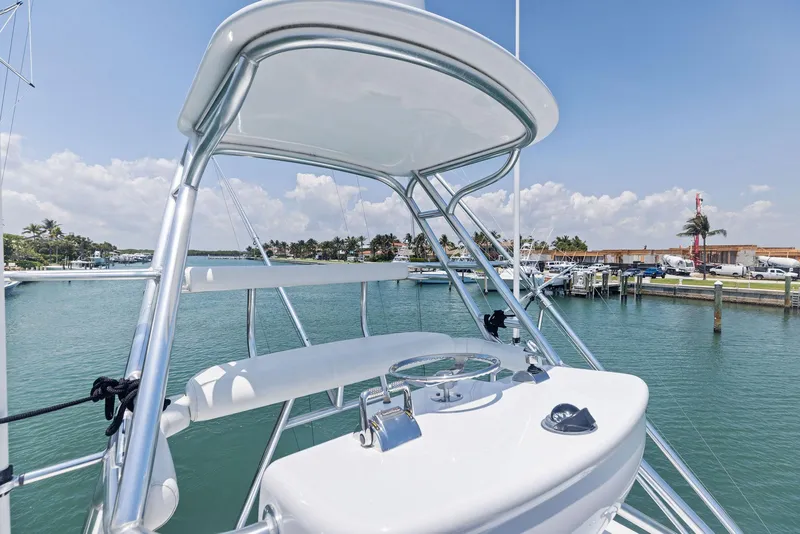 Slide: The Image of 2016 Hatteras Express Sportfish boat with tower, docked in a sunny marina. - 40