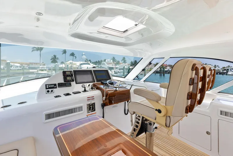 Slide: The Image of 2016 Hatteras Express Sportfish yacht helm with luxurious seating and advanced navigation systems. - 44