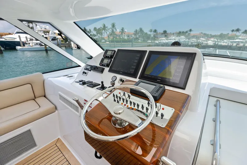 Slide: The Image of 2016 Hatteras Express Sportfish helm with modern navigation displays and controls. - 48