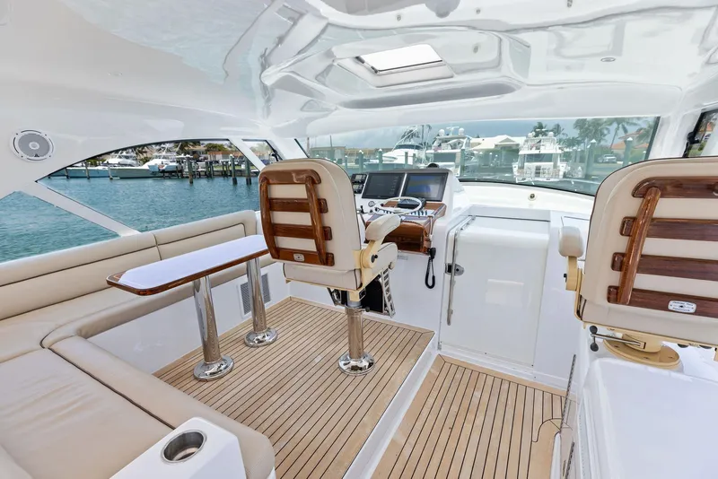 Slide: The Image of 2016 Hatteras Express Sportfish interior with helm, seating, and ocean view. - 49