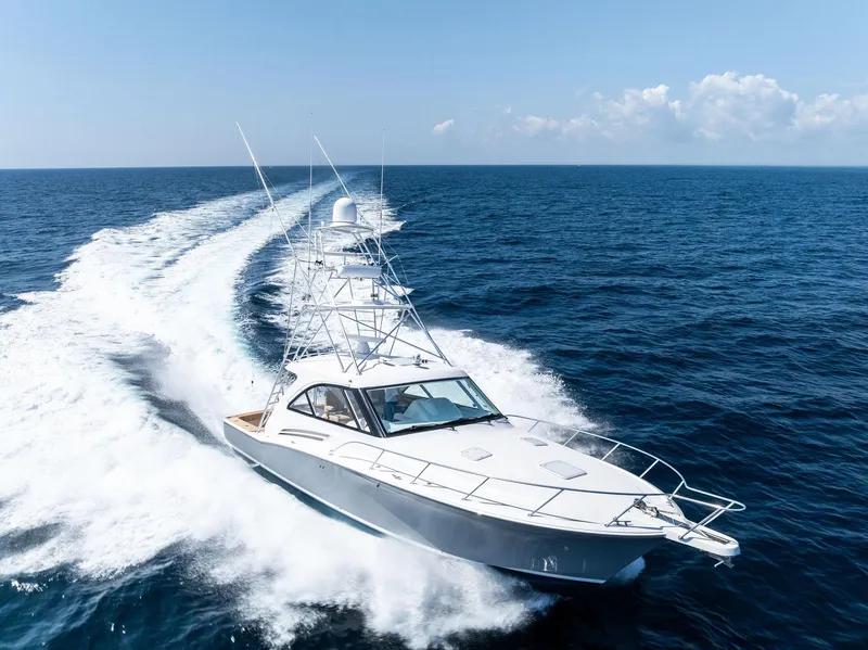 Slide: The Image of 2016 Hatteras Express Sportfish yacht cruising on open ocean under clear skies. - 9