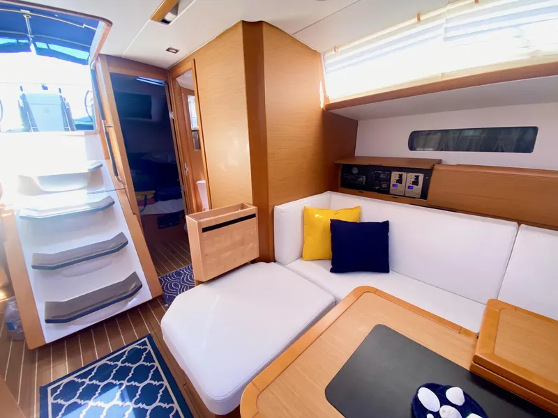 Slide: The Image of Interior of 2016 Jeanneau Sun Odyssey 479 yacht with modern seating and wooden finishes. - 13