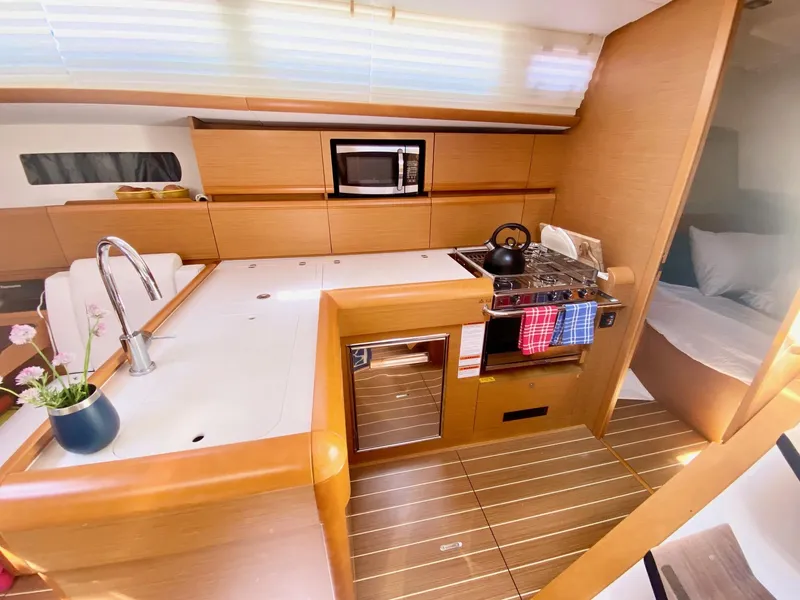 Slide: The Image of Interior of 2016 Jeanneau Sun Odyssey 479 yacht with modern kitchen and cozy cabin. - 16