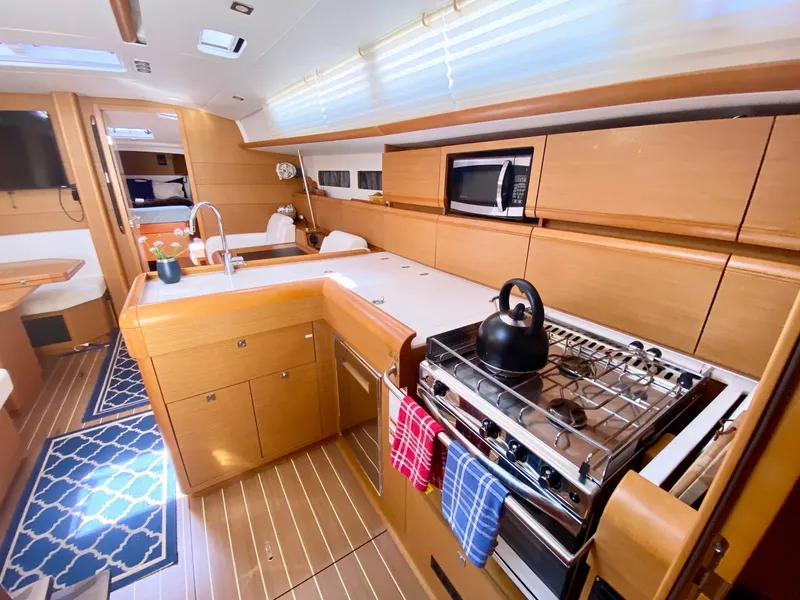 Slide: The Image of Interior of 2016 Jeanneau Sun Odyssey 479 yacht with modern kitchen and cozy dining area. - 20
