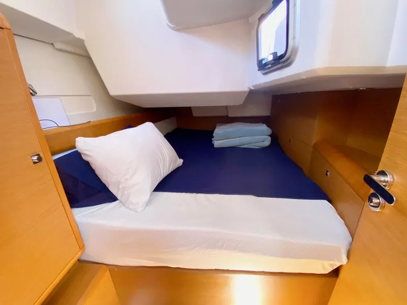 Slide: The Image of Cozy cabin interior of 2016 Jeanneau Sun Odyssey 479 sailboat with bed and window. - 23