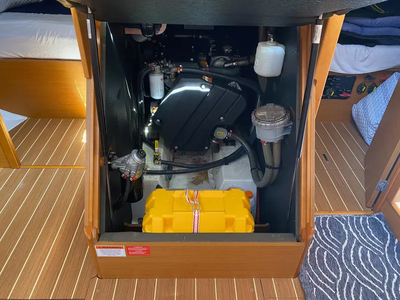 Slide: The Image of Engine compartment of 2016 Jeanneau Sun Odyssey 479 sailboat, showcasing mechanical components. - 24