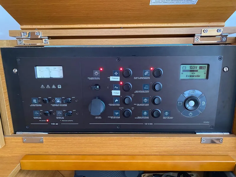 Slide: The Image of Control panel of 2016 Jeanneau Sun Odyssey 479 yacht, featuring various switches and displays. - 25