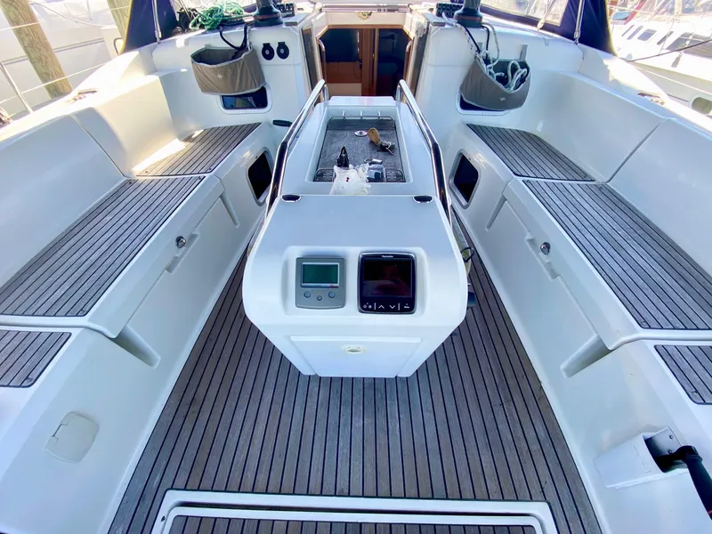 Slide: The Image of Cockpit of 2016 Jeanneau Sun Odyssey 479 sailboat with teak flooring and navigation equipment. - 32