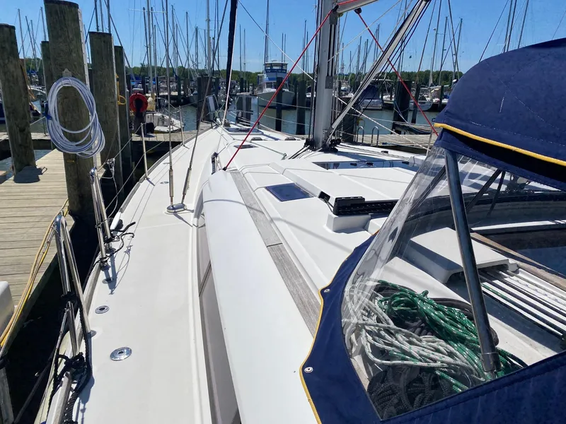 Slide: The Image of 2016 Jeanneau Sun Odyssey 479 sailboat docked at marina, showcasing deck and rigging. - 33