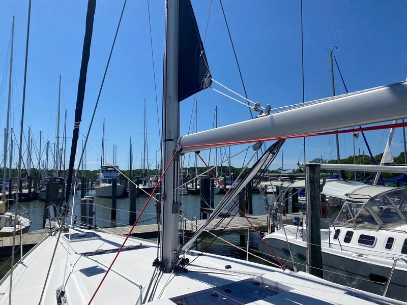 Slide: The Image of 2016 Jeanneau Sun Odyssey 479 sailboat docked at marina under clear blue sky. - 34