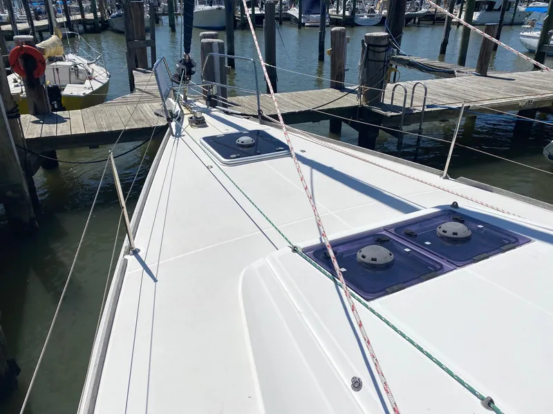 Slide: The Image of 2016 Jeanneau Sun Odyssey 479 docked at marina, showcasing deck and hatches. - 35