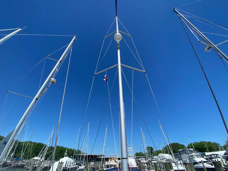 Slide: The Image of Masts of Jeanneau Sun Odyssey 479 sailboat against clear blue sky, 2016 model. - 37