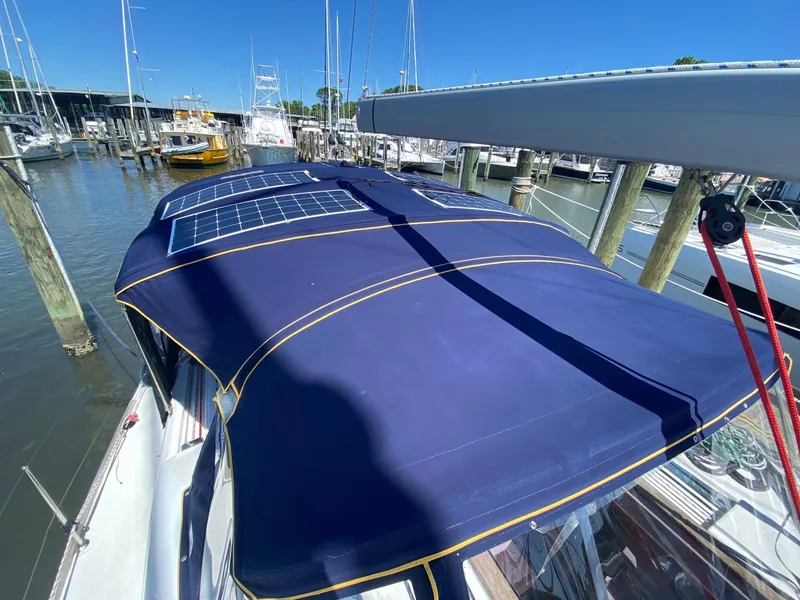 Slide: The Image of Jeanneau Sun Odyssey 479 (2016) with solar panels on blue canopy at marina. - 39