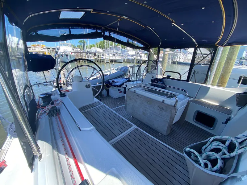 Slide: The Image of 2016 Jeanneau Sun Odyssey 479 yacht cockpit with dual steering wheels and marina view. - 40