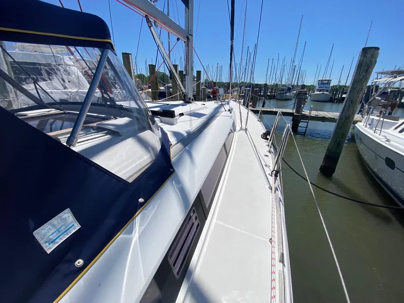 Slide: The Image of 2016 Jeanneau Sun Odyssey 479 sailboat docked at marina under clear blue sky. - 41