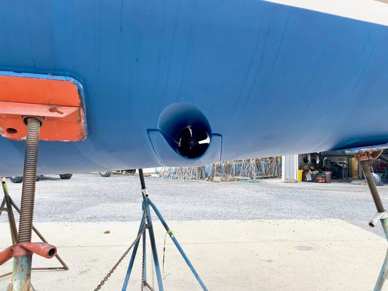 Slide: The Image of 2016 Jeanneau Sun Odyssey 479 hull with bow thruster, supported on stands. - 48