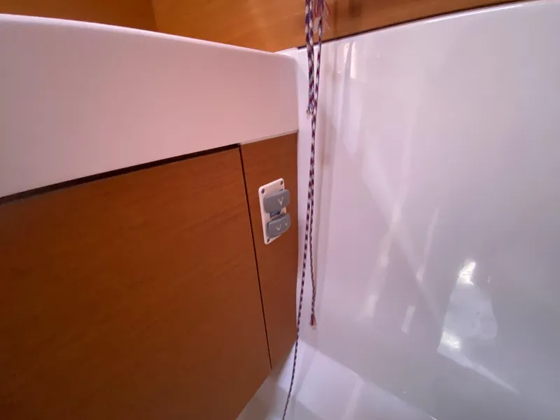 Slide: The Image of Interior detail of 2016 Jeanneau Sun Odyssey 479 yacht, featuring wood paneling and rope. - 8