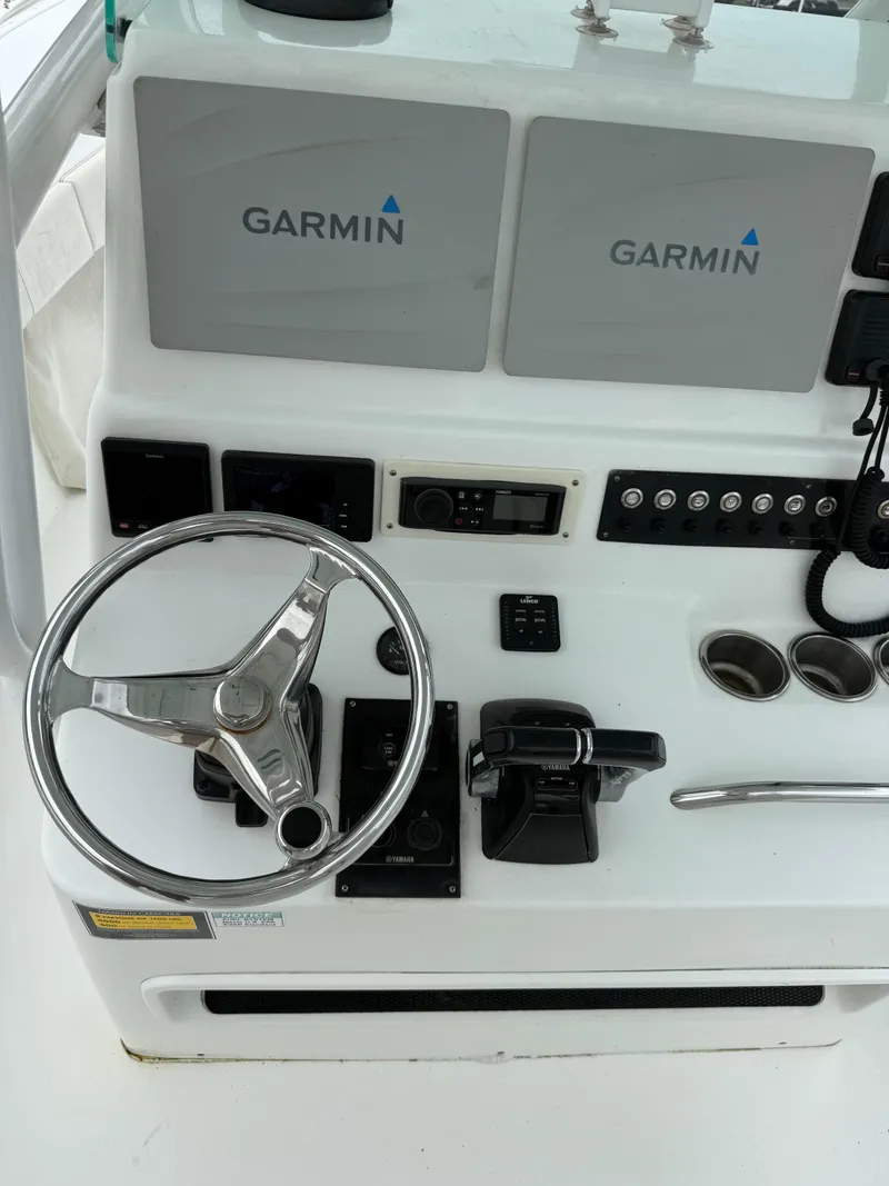 Slide: The Image of 2019 Cape Horn 31 boat dashboard with Garmin navigation displays and steering wheel. - 6