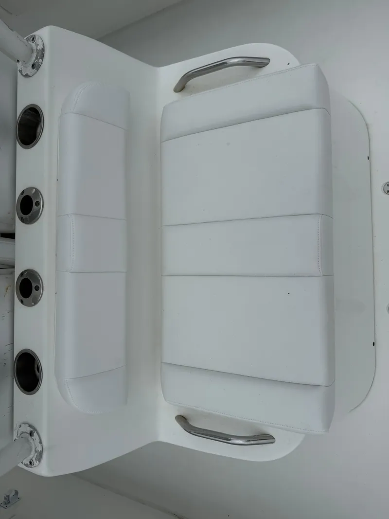 Slide: The Image of White cushioned seating on a 2019 Cape Horn 31 boat with stainless steel handles. - 12