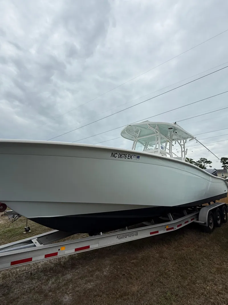 Slide: The Image of 2019 Cape Horn 31 boat on trailer under cloudy sky. - 13