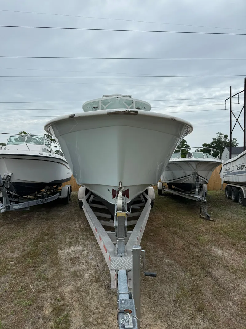 Slide: The Image of 2019 Cape Horn 31 boat on trailer, parked outdoors under cloudy sky. - 17