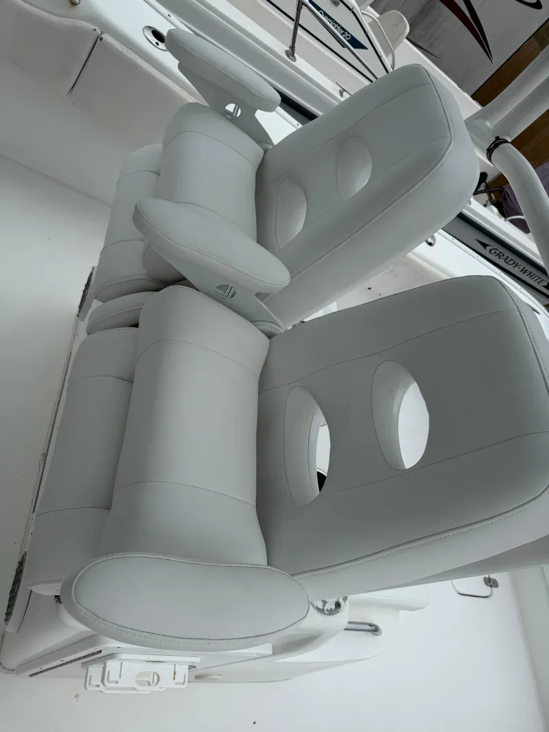 Slide: The Image of 2019 Cape Horn 31 boat with white cushioned seats and armrests. - 7