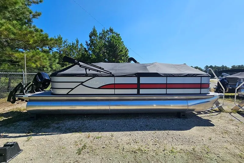 The Image of 2025 Bentley Pontoons Legacy 243 Navigator, covered, parked outdoors, surrounded by trees. - 0