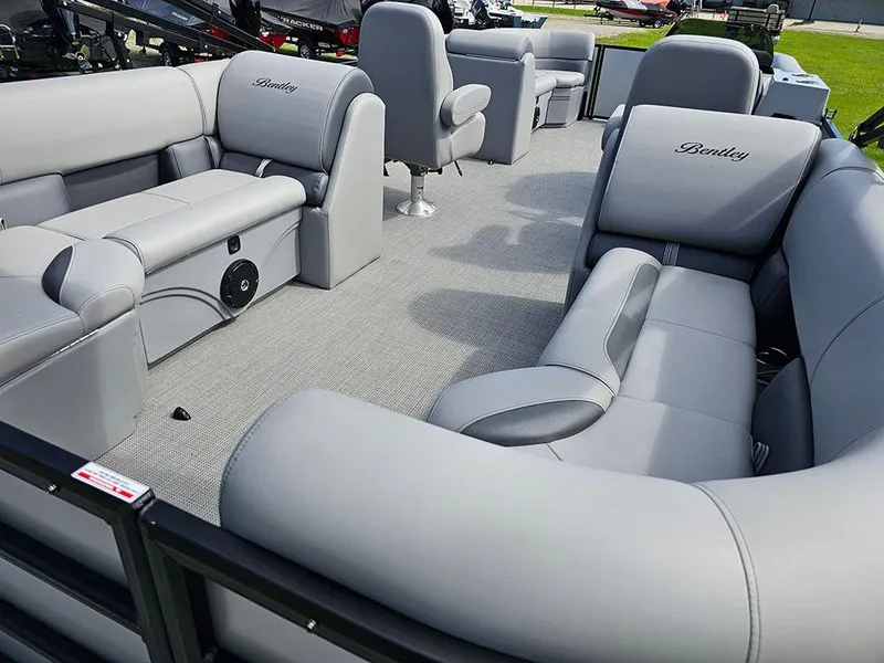 Slide: The Image of 2025 Bentley Pontoons Legacy 243 Navigator on grassy field under blue sky. - 10