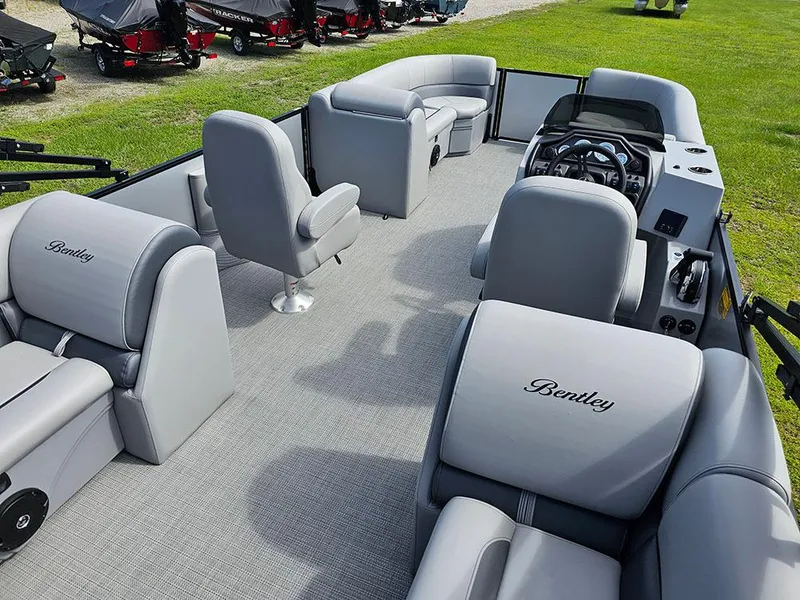 Slide: The Image of 2025 Bentley Pontoons Legacy 243 Navigator on grassy field under blue sky. - 11