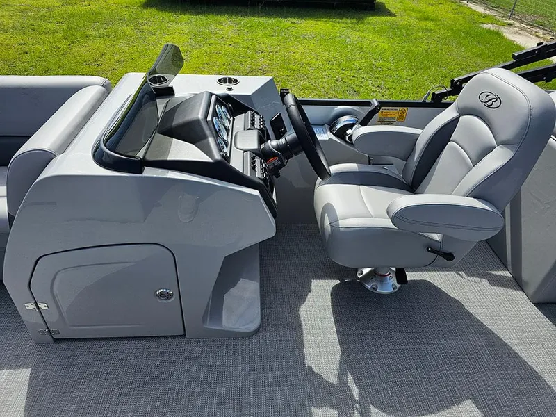 Slide: The Image of 2025 Bentley Pontoons Legacy 243 Navigator interior with luxurious seating and modern helm. - 17