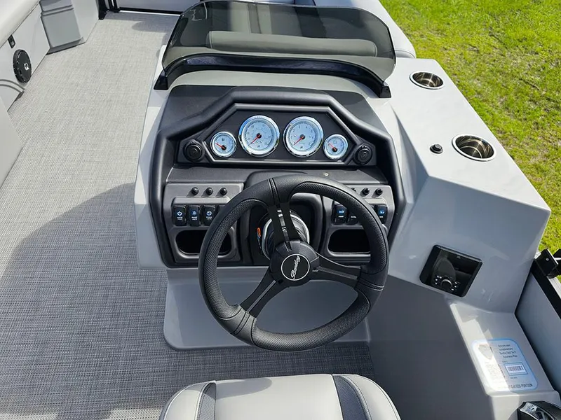 Slide: The Image of 2025 Bentley Pontoons Legacy 243 Navigator dashboard with steering wheel and gauges. - 21