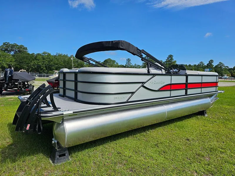 Slide: The Image of 2025 Bentley Pontoons Legacy 243 Navigator on grass under blue sky. - 3