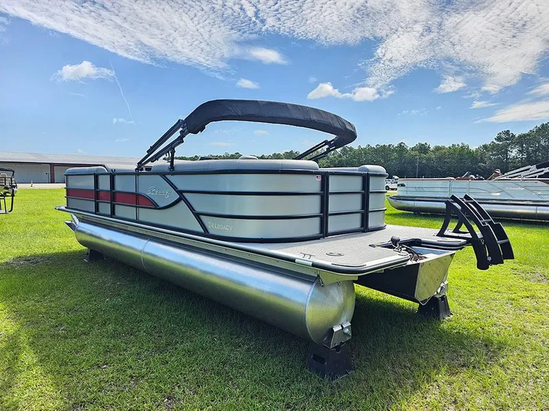 Slide: The Image of 2025 Bentley Pontoons Legacy 243 Navigator on grass under blue sky. - 8
