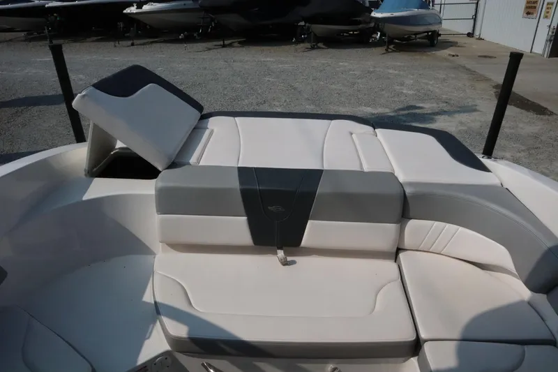 Slide: The Image of 2020 Chaparral 23 SSi boat interior with cushioned seating and storage compartment. - 13