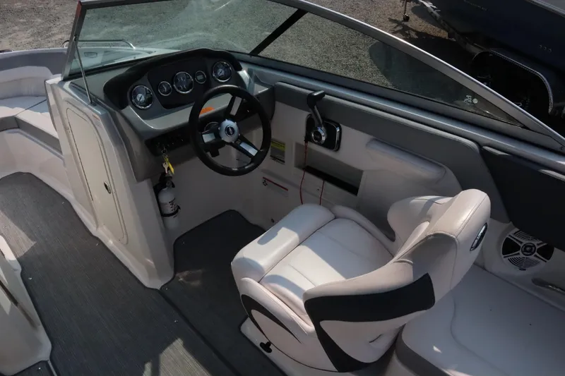 Slide: The Image of 2020 Chaparral 23 SSi boat interior with steering wheel and captain's seat. - 8