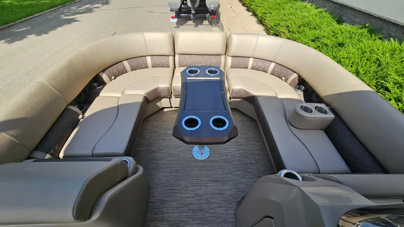 Slide: The Image of 2021 Bennington L 22 Quad Bench interior with plush seating and cup holders. - 10