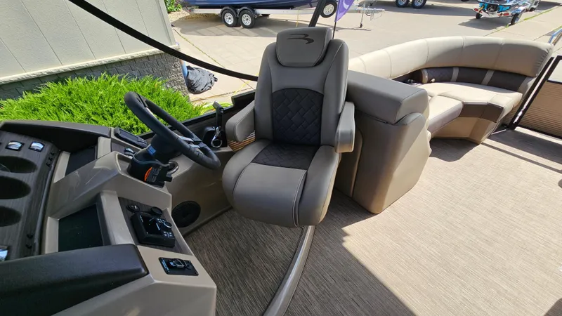 Slide: The Image of 2021 Bennington L 22 Quad Bench interior with steering wheel and seating. - 14