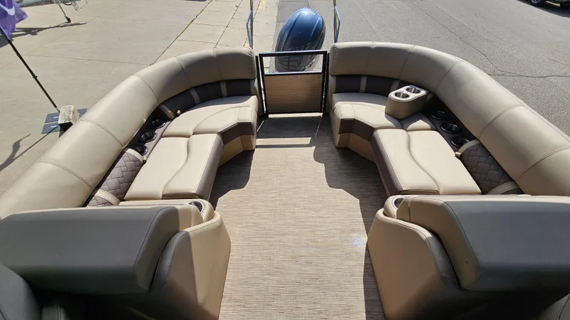 Slide: The Image of 2021 Bennington L 22 Quad Bench interior with plush seating and cup holders. - 15