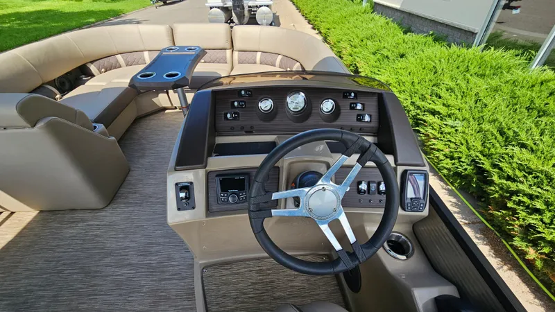 Slide: The Image of 2021 Bennington L 22 Quad Bench boat interior with steering wheel and seating area. - 18