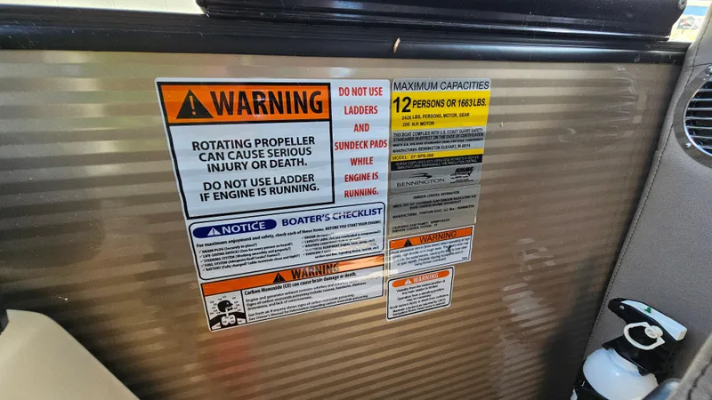 Slide: The Image of Warning labels on 2021 Bennington L 22 Quad Bench boat interior. - 20