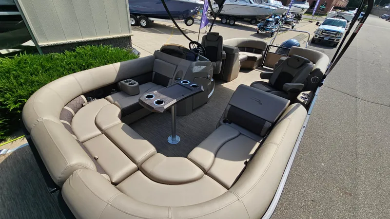 Slide: The Image of 2021 Bennington L 22 Quad Bench pontoon boat with spacious seating and cup holders. - 23