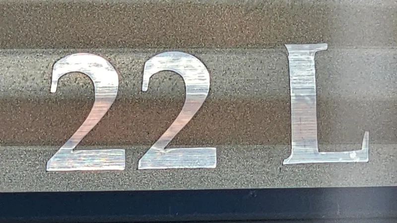Slide: The Image of Metallic '22 L' emblem on Bennington L 22 Quad Bench, 2021 model. - 25