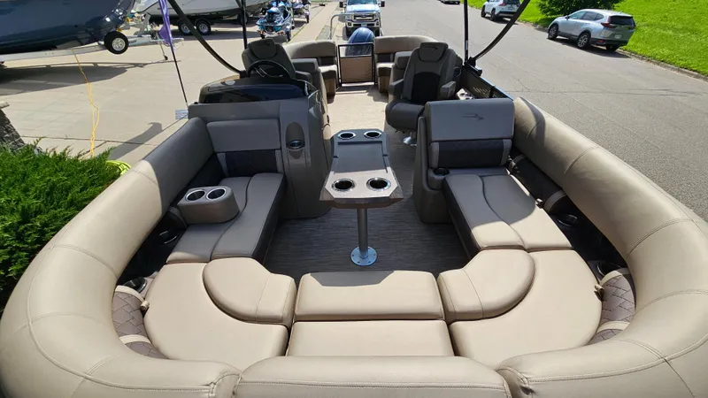 Slide: The Image of 2021 Bennington L 22 Quad Bench pontoon boat with spacious seating and cup holders. - 9