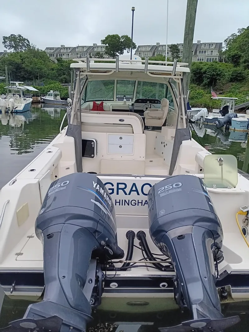 Slide: The Image of 2009 Pursuit 310 OS boat with twin Yamaha 250 engines docked in a marina. - 3