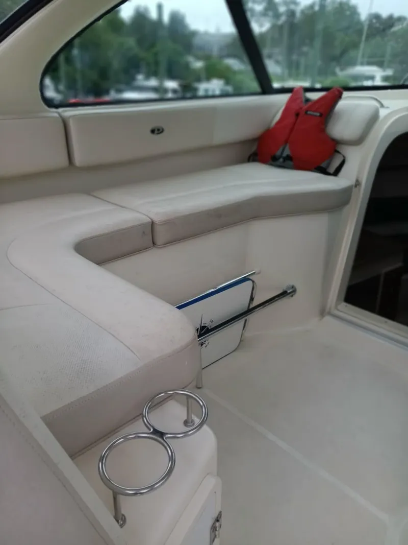 Slide: The Image of Interior of a 2009 Pursuit 310 OS boat with seating and cup holders. - 6